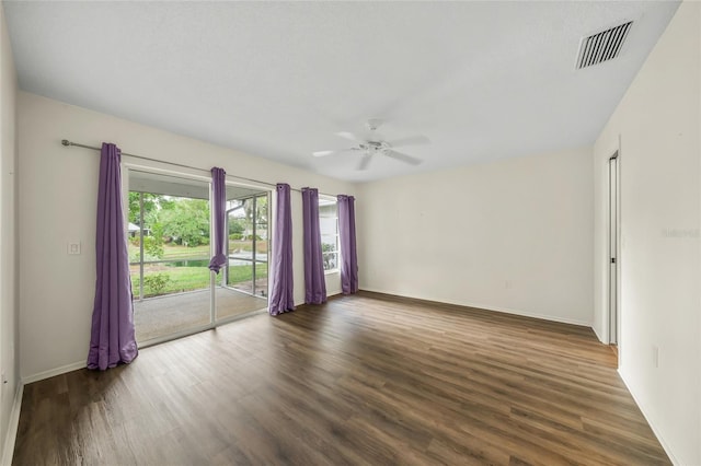 unfurnished room with ceiling fan and dark hardwood / wood-style flooring