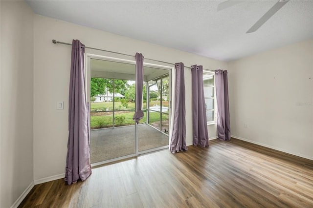 spare room featuring ceiling fan, wood-type flooring, and a textured ceiling