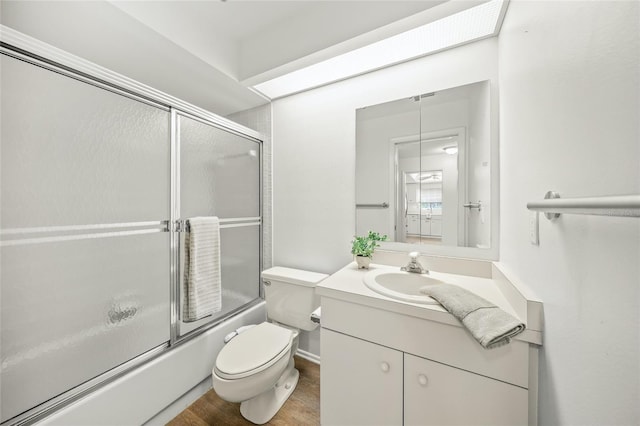 3653 Bonaventure Ct, Sarasota, FL 34243 - bathroom featuring toilet, enclosed tub / shower combo, vanity, and wood finished floors