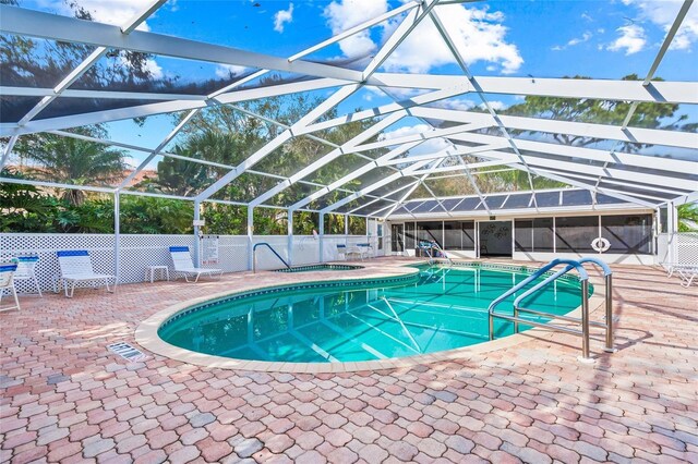 view of pool with a patio area and a lanai