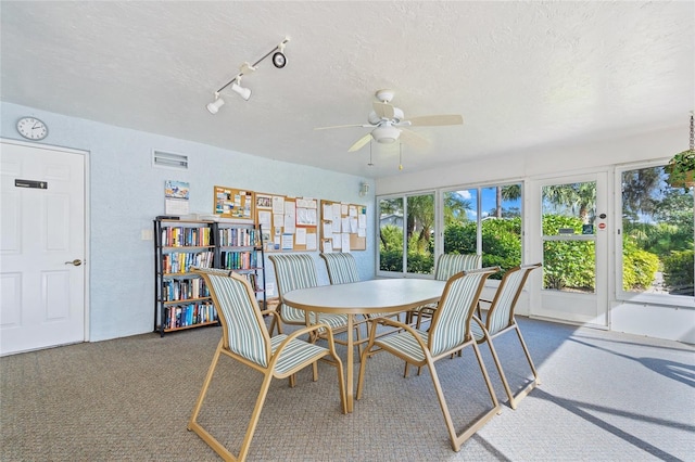 3653 Bonaventure Ct, Sarasota, FL 34243 - dining room featuring a ceiling fan, a textured ceiling, and carpet flooring