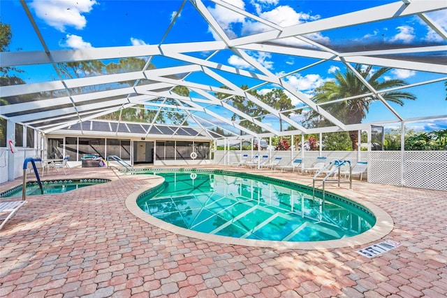 view of pool with a patio and glass enclosure