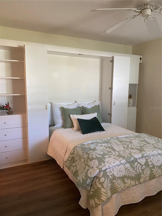 3653 Bonaventure Ct, Sarasota, FL 34243 - bedroom with dark wood finished floors, a textured ceiling, and ceiling fan