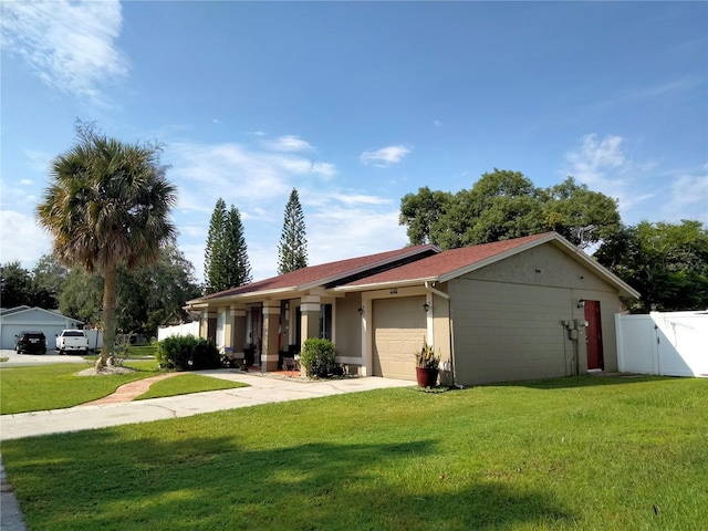 ranch-style house with a garage and a front lawn