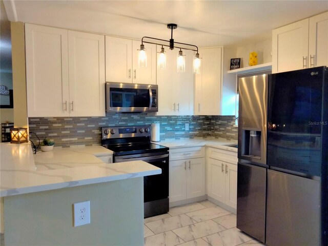 kitchen featuring appliances with stainless steel finishes, white cabinetry, kitchen peninsula, light stone countertops, and pendant lighting