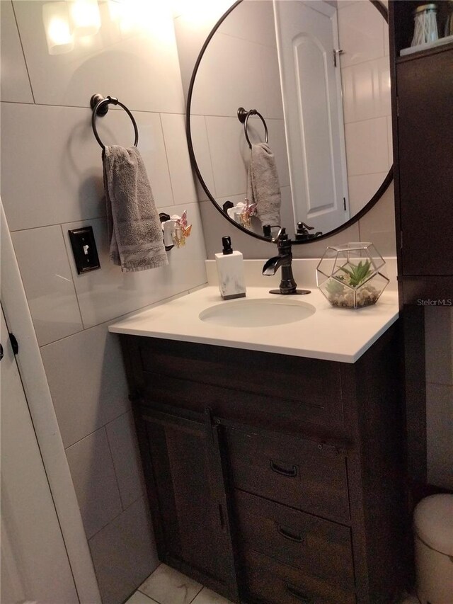 bathroom featuring tile walls and vanity