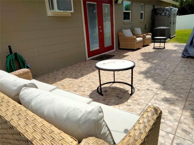 view of patio featuring french doors, cooling unit, and an outdoor living space