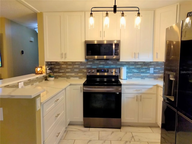 kitchen featuring white cabinetry, kitchen peninsula, backsplash, appliances with stainless steel finishes, and decorative light fixtures