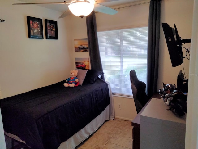 tiled bedroom featuring ceiling fan