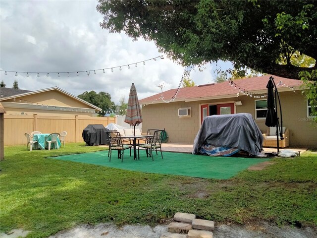 back of house featuring a yard and a patio area