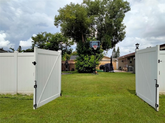 view of yard with central AC unit and a storage unit