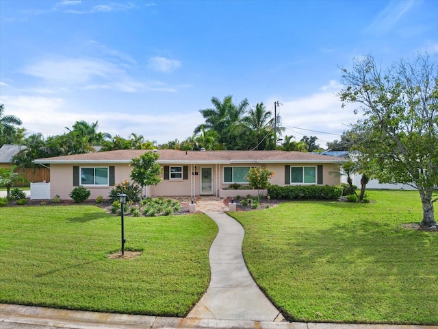 ranch-style home featuring a front yard