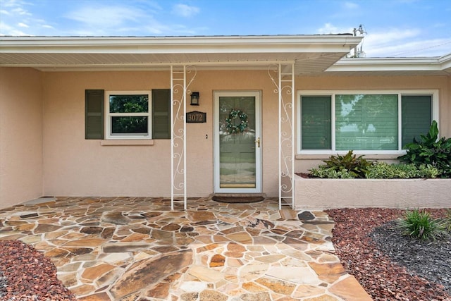 property entrance featuring a patio