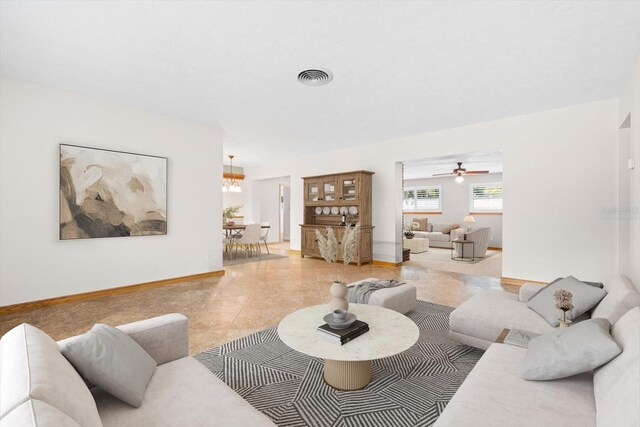 living room with ceiling fan and light tile patterned flooring