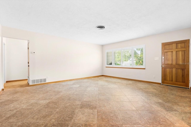 spare room with a textured ceiling