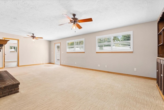 unfurnished living room featuring ceiling fan, plenty of natural light, and light carpet