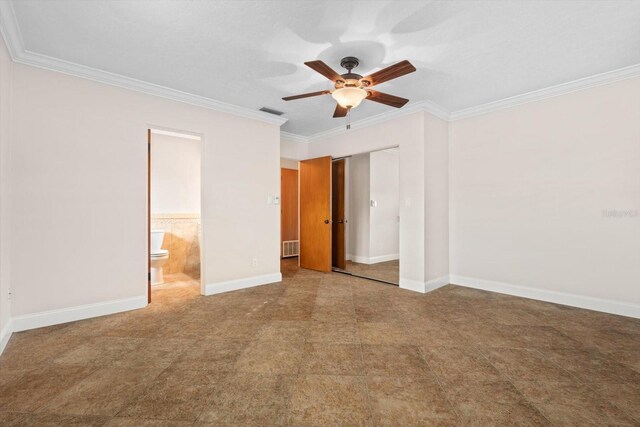 unfurnished bedroom with ceiling fan, ornamental molding, a closet, and ensuite bathroom