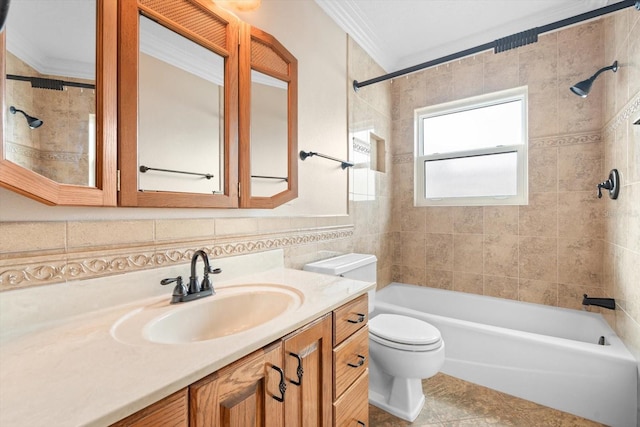 full bathroom with vanity, crown molding, toilet, tile walls, and tiled shower / bath