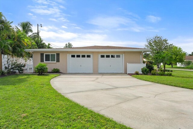 view of front of property with a garage and a front lawn