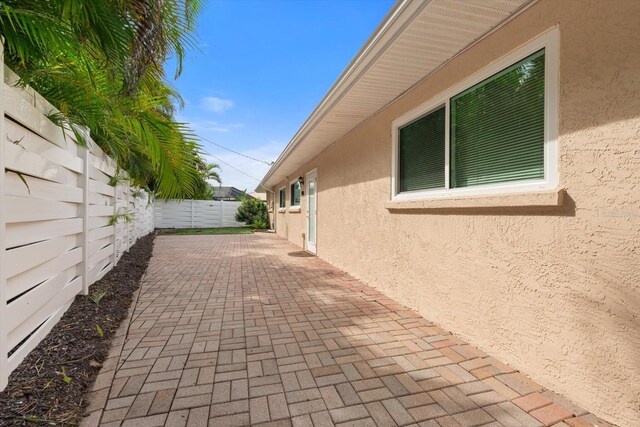 view of side of property with a patio