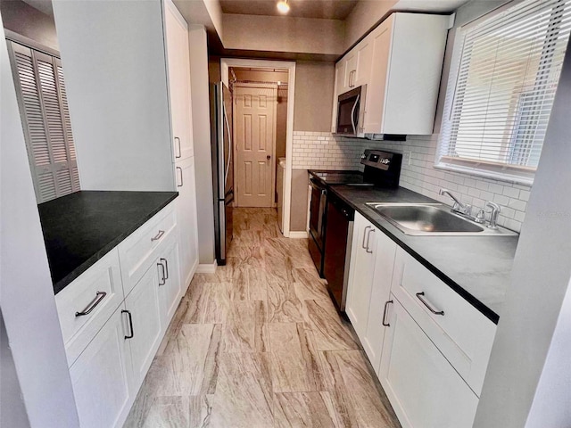 kitchen with stainless steel appliances, sink, decorative backsplash, and white cabinets