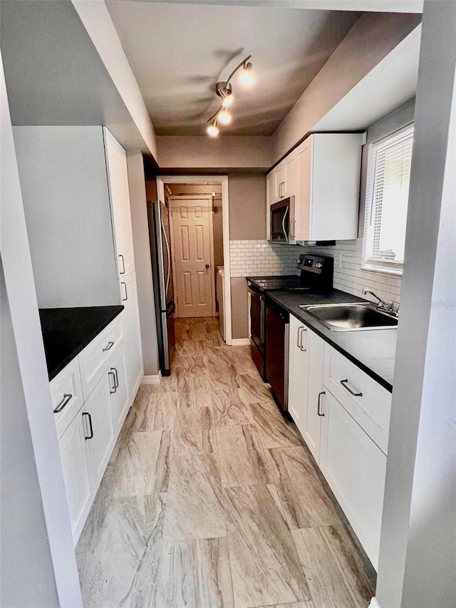 kitchen featuring stainless steel appliances, sink, decorative backsplash, and white cabinetry