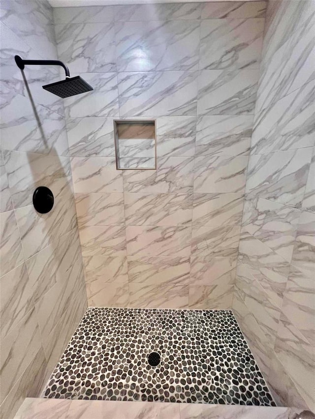 bathroom with tiled shower