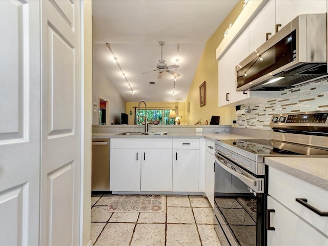 kitchen featuring lofted ceiling, ceiling fan, appliances with stainless steel finishes, backsplash, and white cabinets