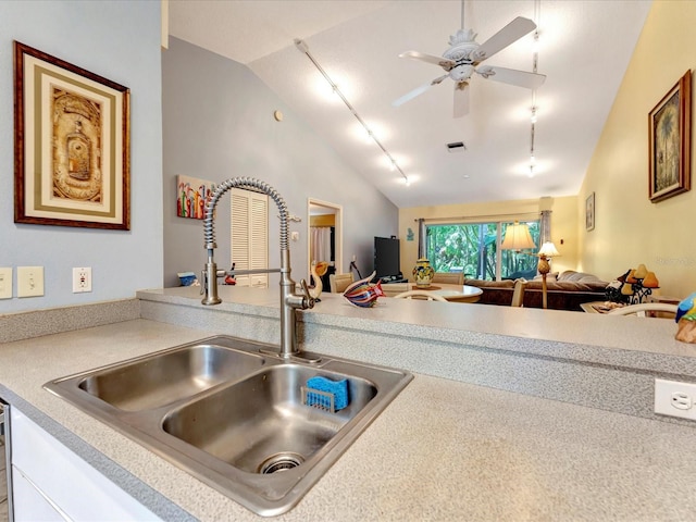 kitchen featuring ceiling fan, high vaulted ceiling, and sink