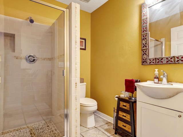 bathroom featuring vanity, toilet, and walk in shower