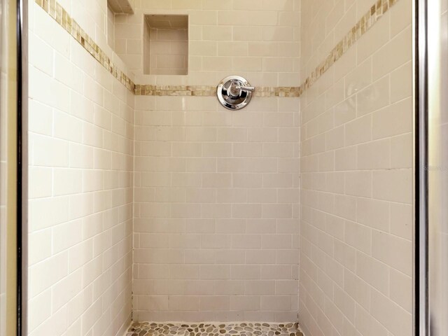 bathroom with tiled shower