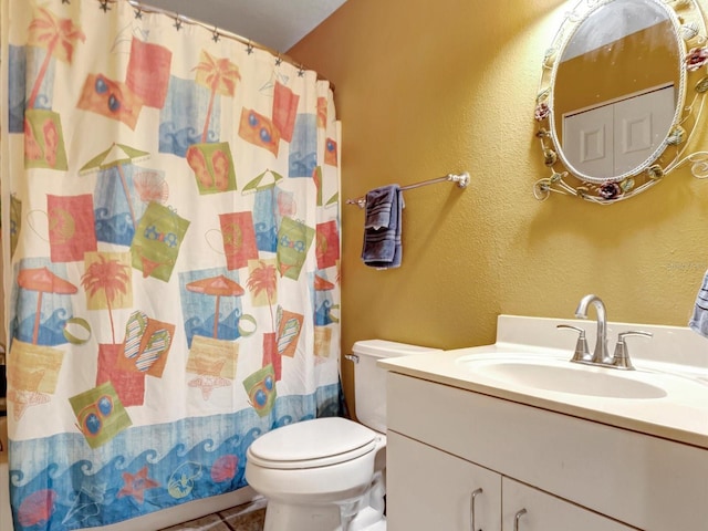 bathroom featuring walk in shower, tile patterned floors, vanity, and toilet