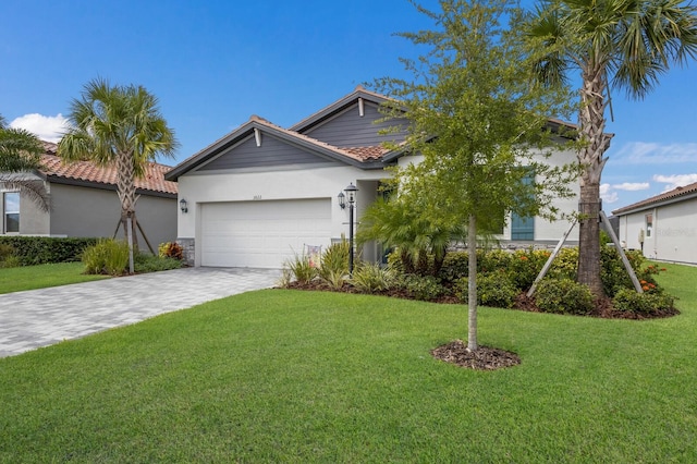 view of front of property with a front yard and a garage