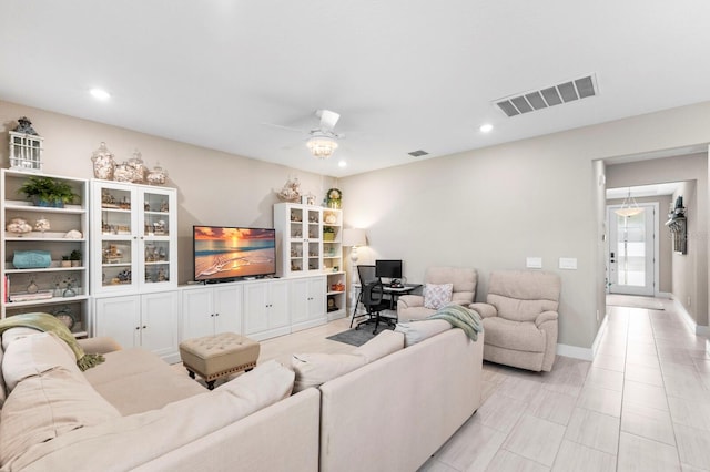 living room with light tile patterned floors and ceiling fan