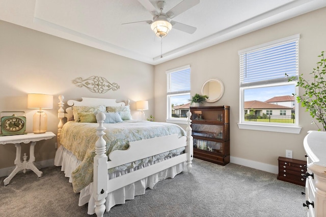 bedroom with ceiling fan, multiple windows, and carpet floors