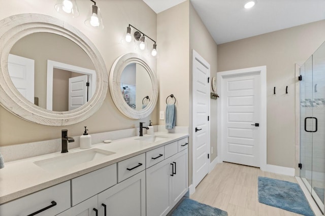 bathroom featuring vanity and a shower with shower door