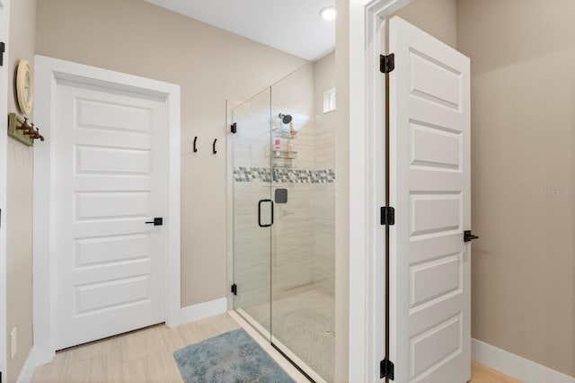 bathroom with a shower with door