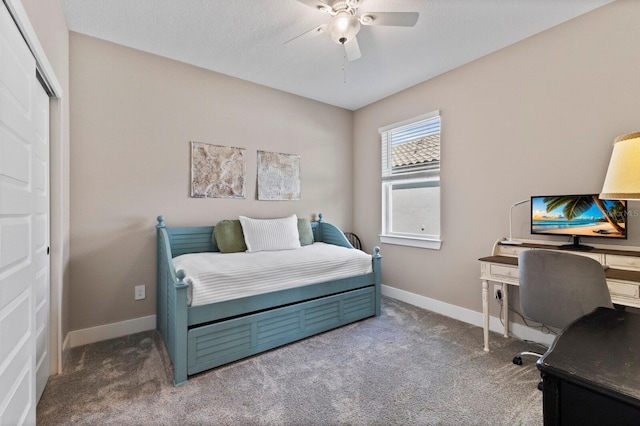 bedroom featuring ceiling fan, a closet, and dark carpet