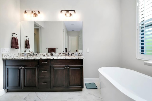 bathroom featuring vanity and a bath