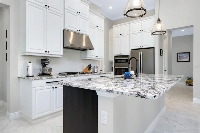 kitchen with white cabinetry, an island with sink, stainless steel appliances, and decorative light fixtures