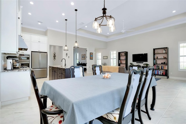 dining room featuring marble finish floor, a tray ceiling, recessed lighting, and crown molding