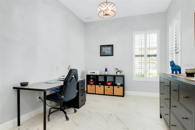 office space with an inviting chandelier and a wealth of natural light