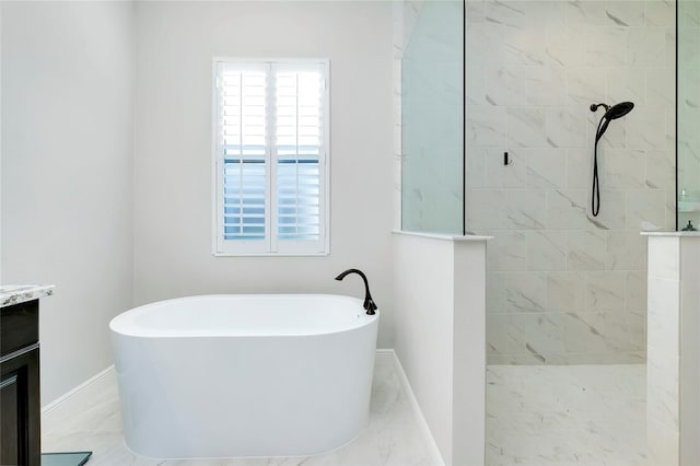 bathroom featuring marble finish floor, a soaking tub, vanity, and walk in shower