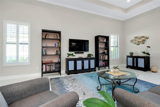 living area featuring a wealth of natural light, crown molding, baseboards, and tile patterned floors