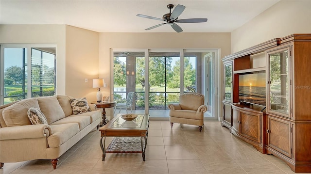 tiled living room featuring ceiling fan and plenty of natural light