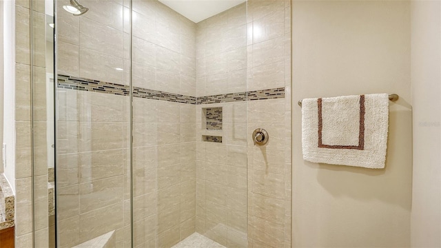 bathroom with a tile shower