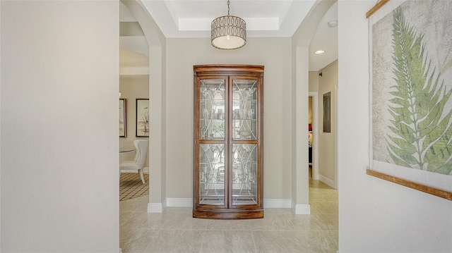 entryway featuring a tray ceiling