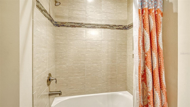 bathroom with shower / bath combo with shower curtain