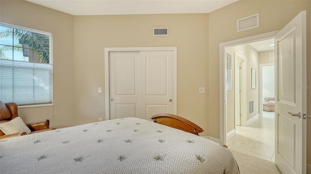 bedroom featuring light tile patterned floors and a closet