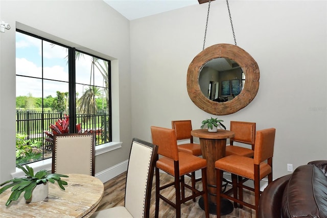 dining space with wood-type flooring